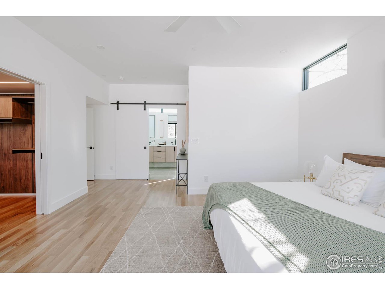 1175 Georgetown Road Boulder, CO 80305 - Photo 18 of 40 Designed for comfort and light. Modern barn door leads to spa-like primary bathroom