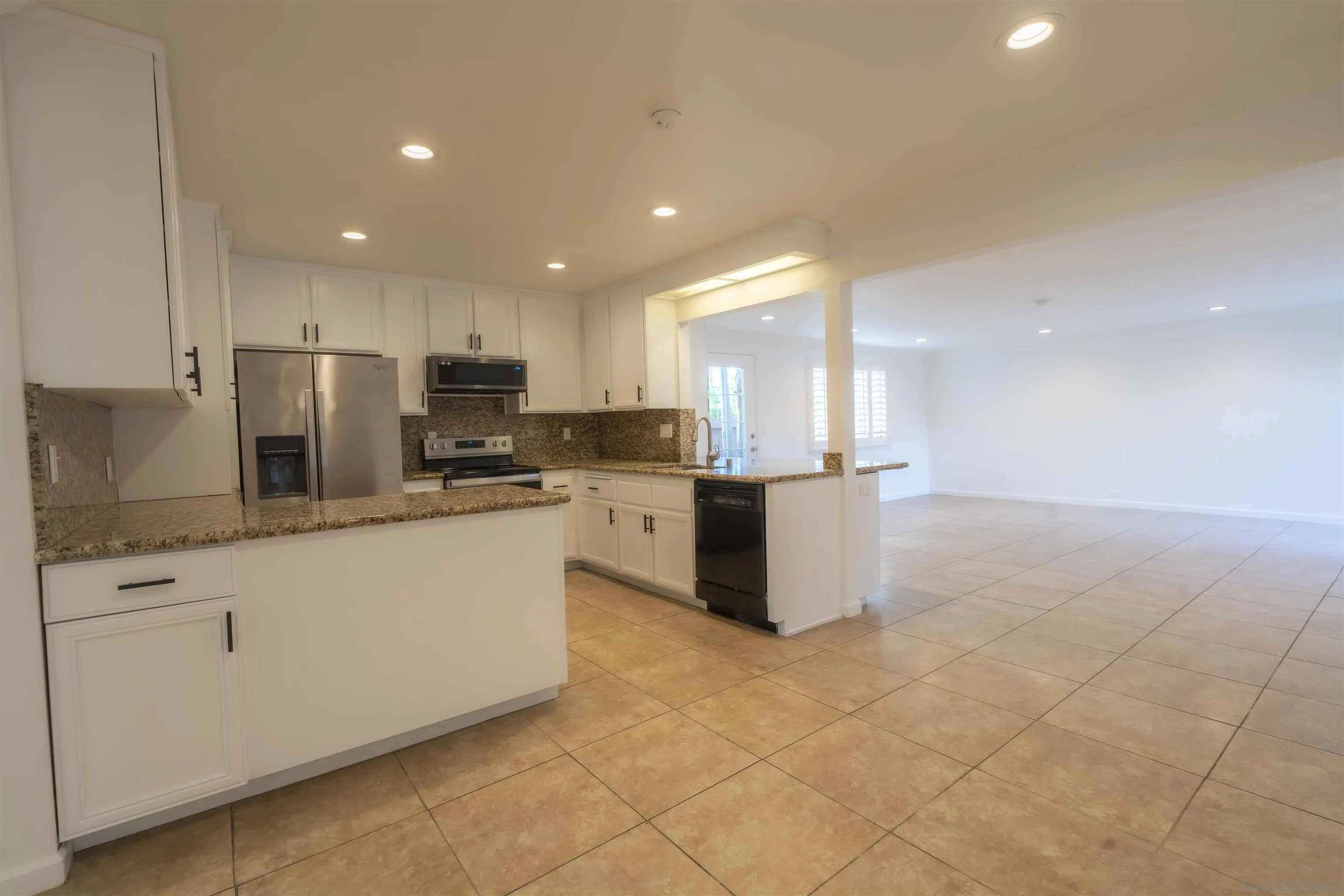 10858 Buggywhip Drive Spring Valley, CA 91978 - Photo 14 of 51 a kitchen with stainless steel appliances granite countertop a sink and a refrigerator