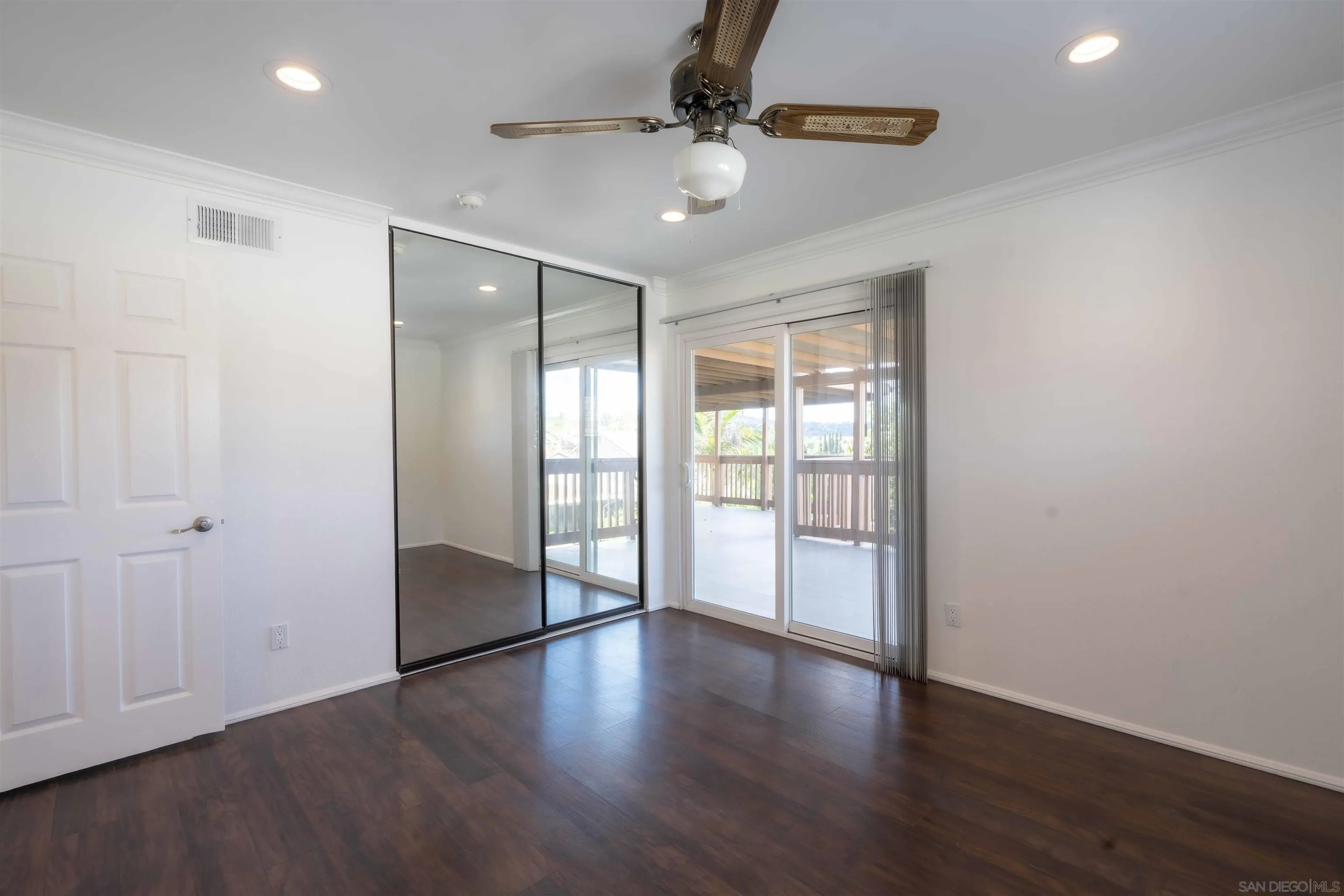 10858 Buggywhip Drive Spring Valley, CA 91978 - Photo 27 of 51 a view of an empty room with window and wooden floor