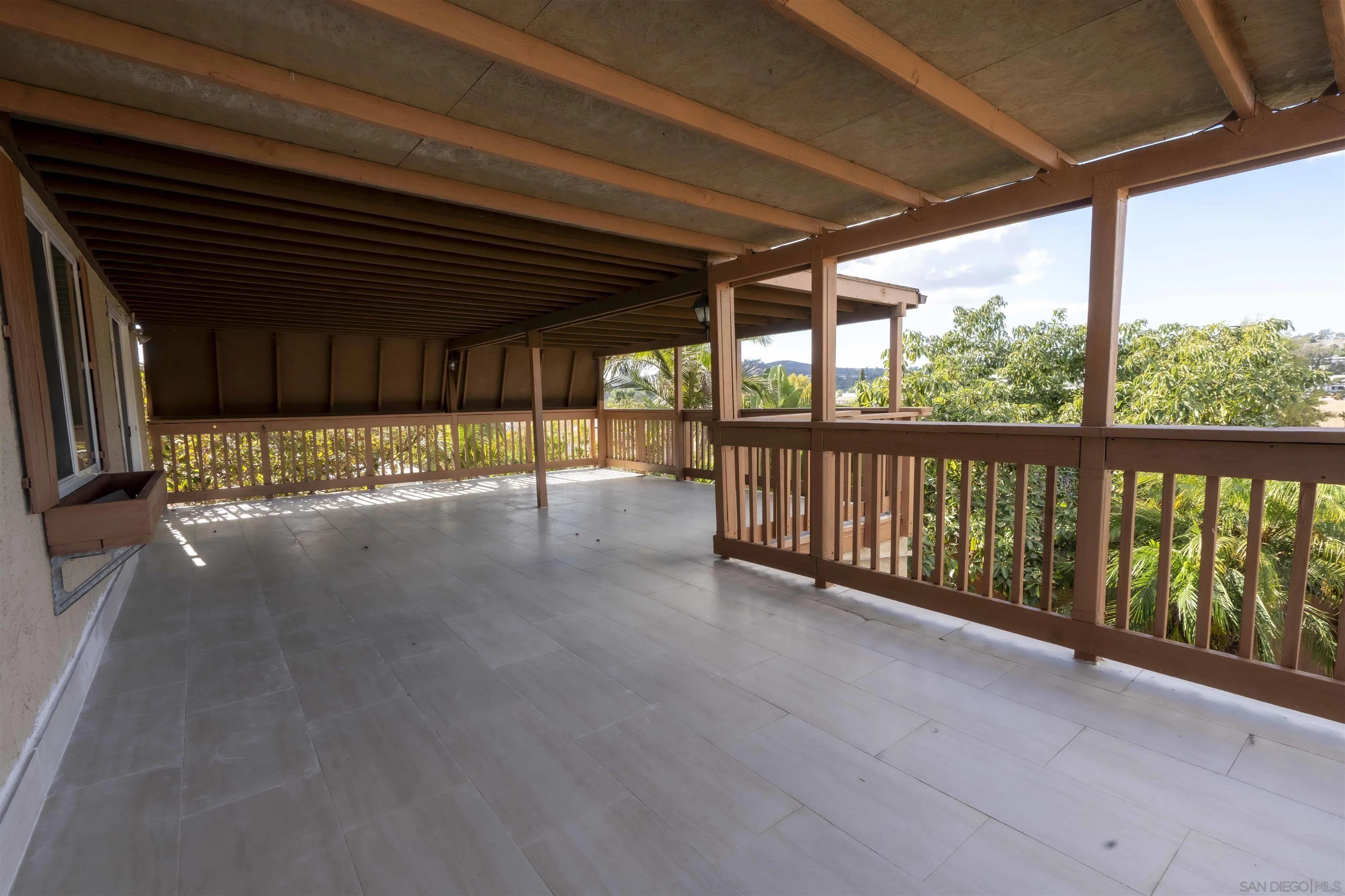 10858 Buggywhip Drive Spring Valley, CA 91978 - Photo 35 of 51 a view of a porch with wooden floor