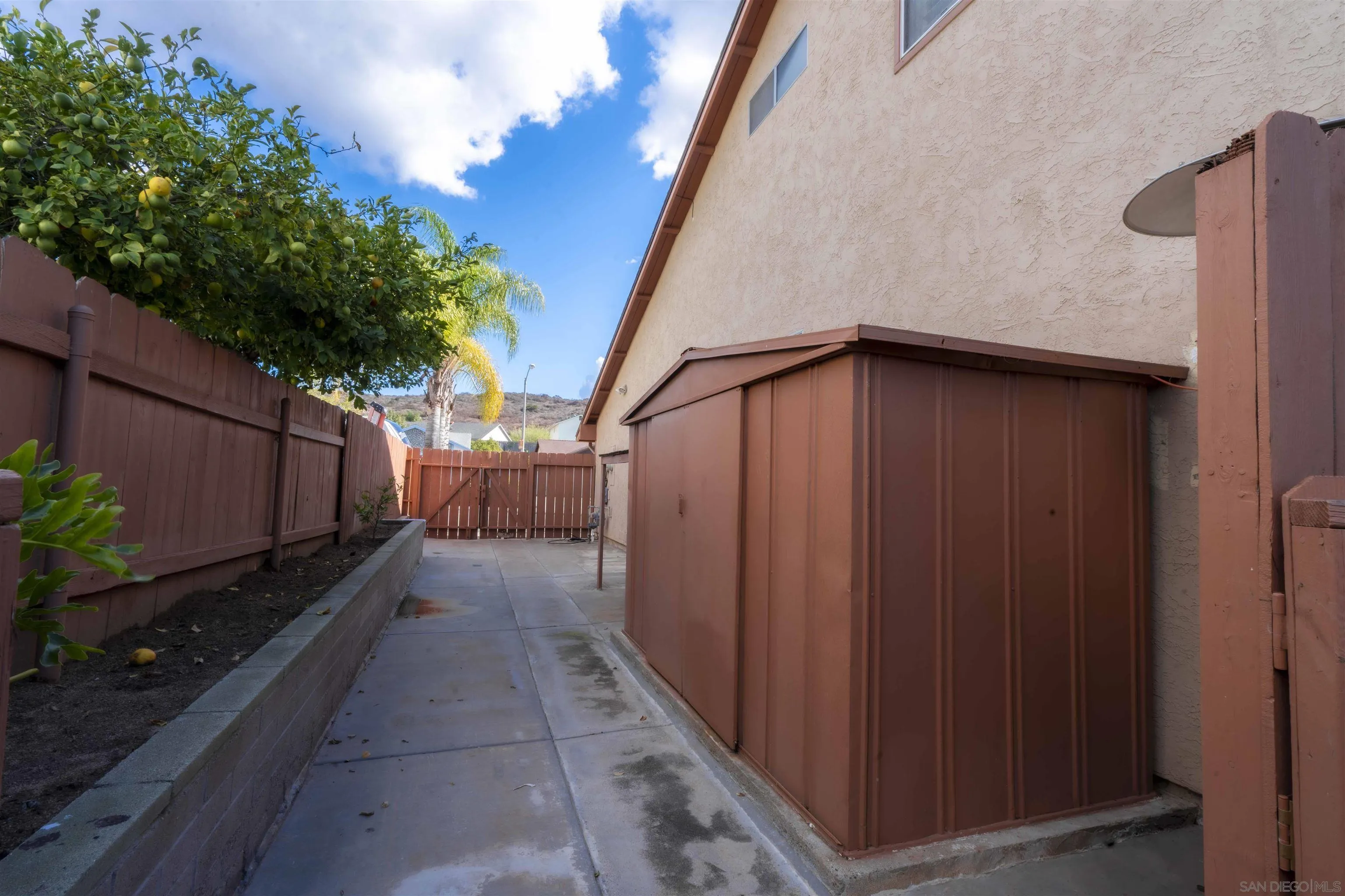 10858 Buggywhip Drive Spring Valley, CA 91978 - Photo 43 of 51 a view of a pathway of a house with wooden fence