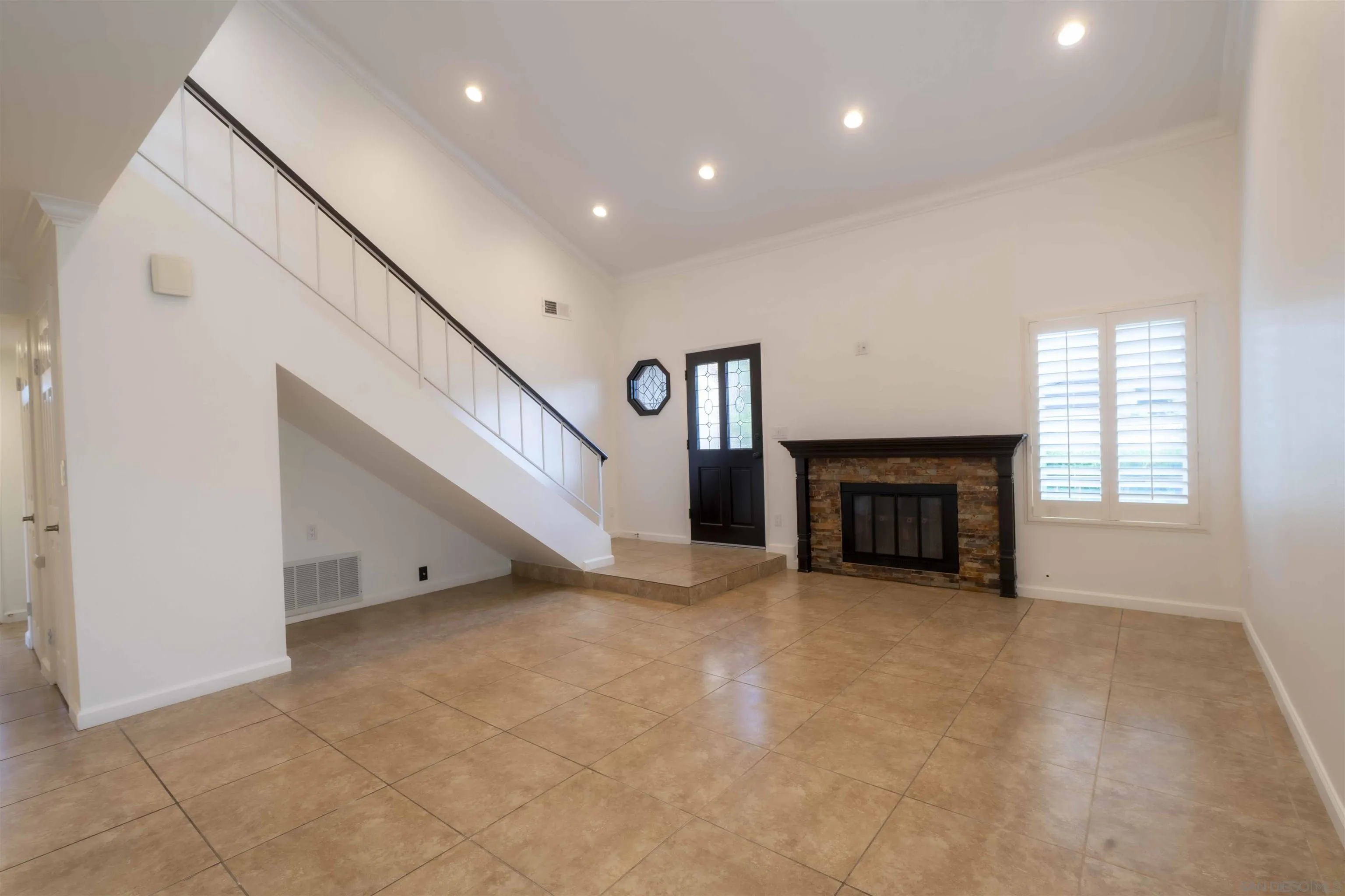10858 Buggywhip Drive Spring Valley, CA 91978 - Photo 9 of 51 a view of an empty room with a fireplace