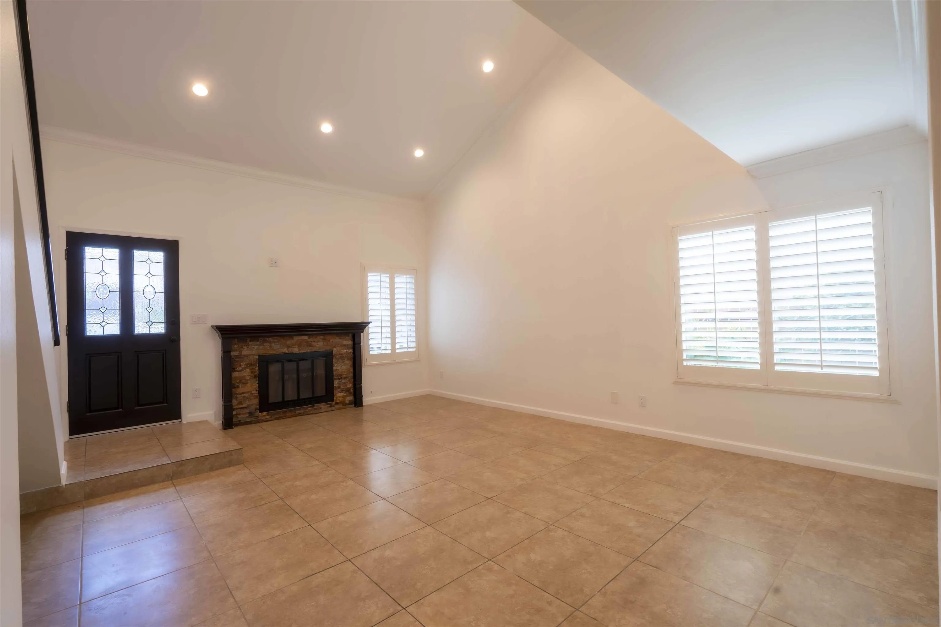 10858 Buggywhip Drive Spring Valley, CA 91978 - Photo 10 of 51 an empty room with fireplace and windows