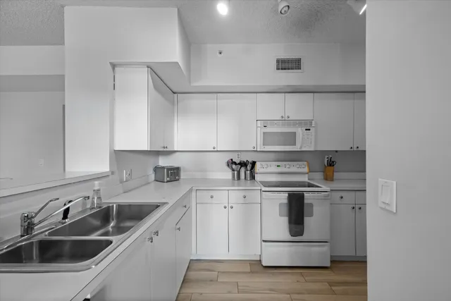 a kitchen with a sink cabinets and stainless steel appliances
