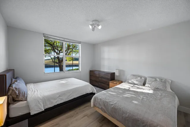 a bedroom with two beds and a window