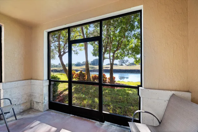 a view of a living room filled with furniture and a window