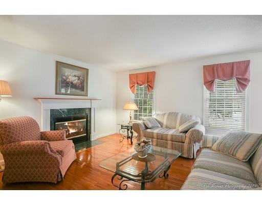 22 Garrison Road Dracut, MA 01826 - Photo 17 of 36 a living room with furniture a fireplace and a large mirror