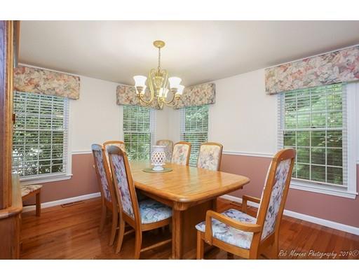 22 Garrison Road Dracut, MA 01826 - Photo 18 of 36 a view of a dining room with furniture wooden floor and chandelier