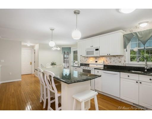 22 Garrison Road Dracut, MA 01826 - Photo 20 of 36 a kitchen with stainless steel appliances granite countertop a sink a stove a dining table and chairs