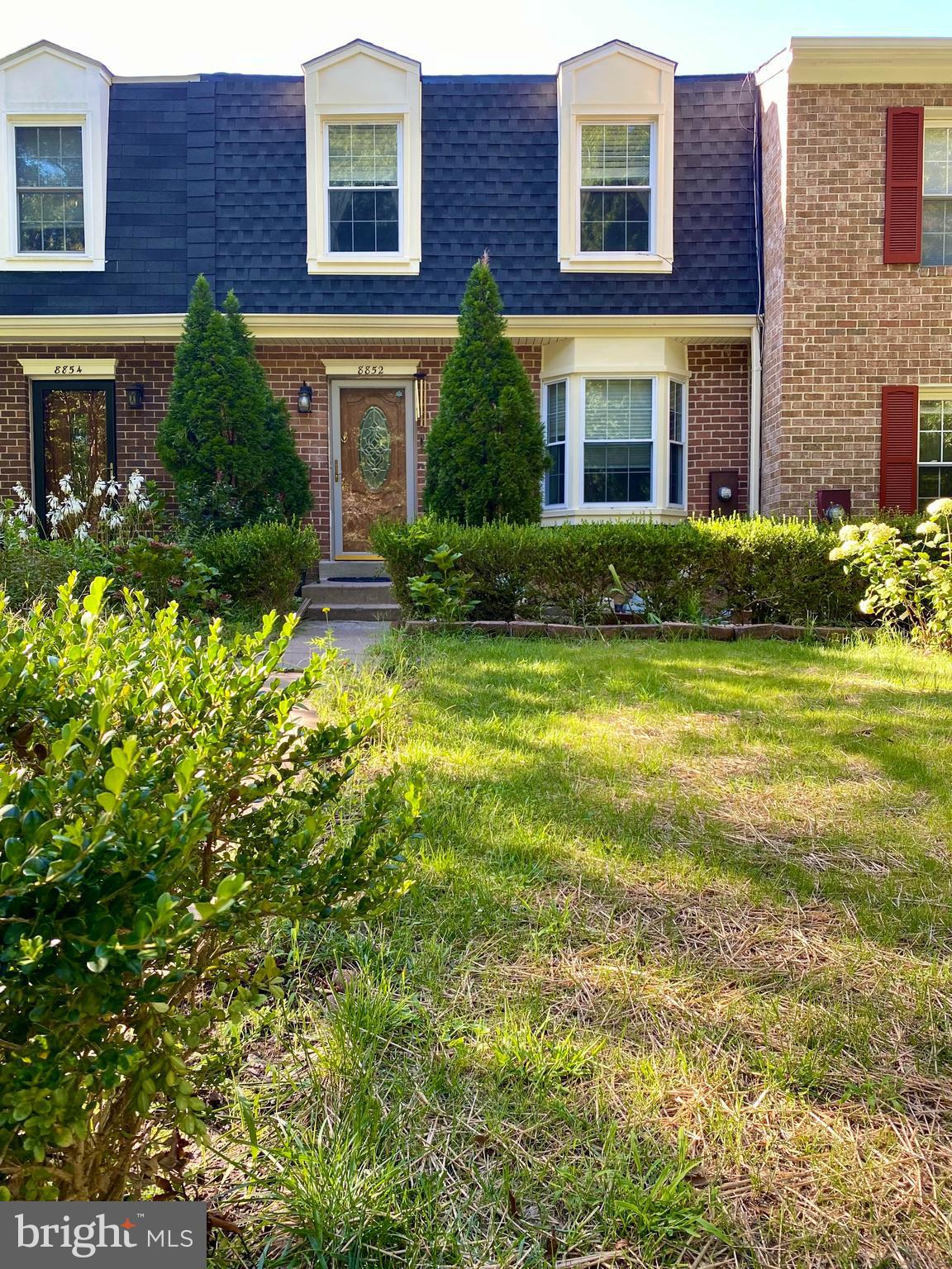 a view of a brick building next to a yard