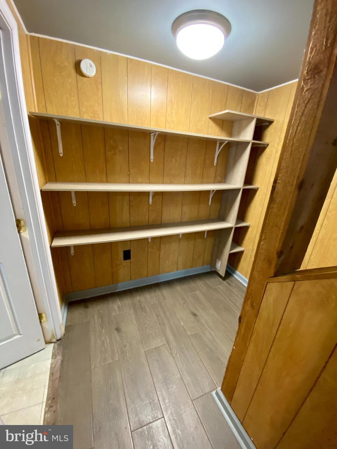 8852 Cork County Court Springfield, VA 22152 - Photo 23 of 31 a view of walk in closet with empty racks