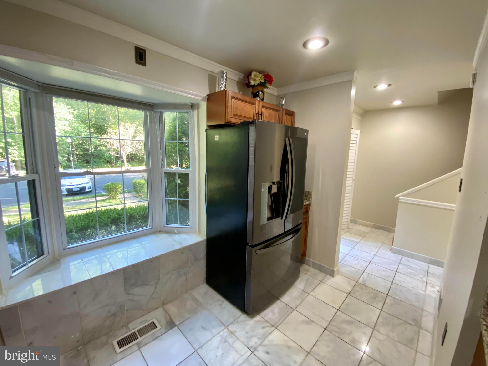 8852 Cork County Court Springfield, VA 22152 - Photo 5 of 31 a view of a refrigerator in kitchen and an empty room