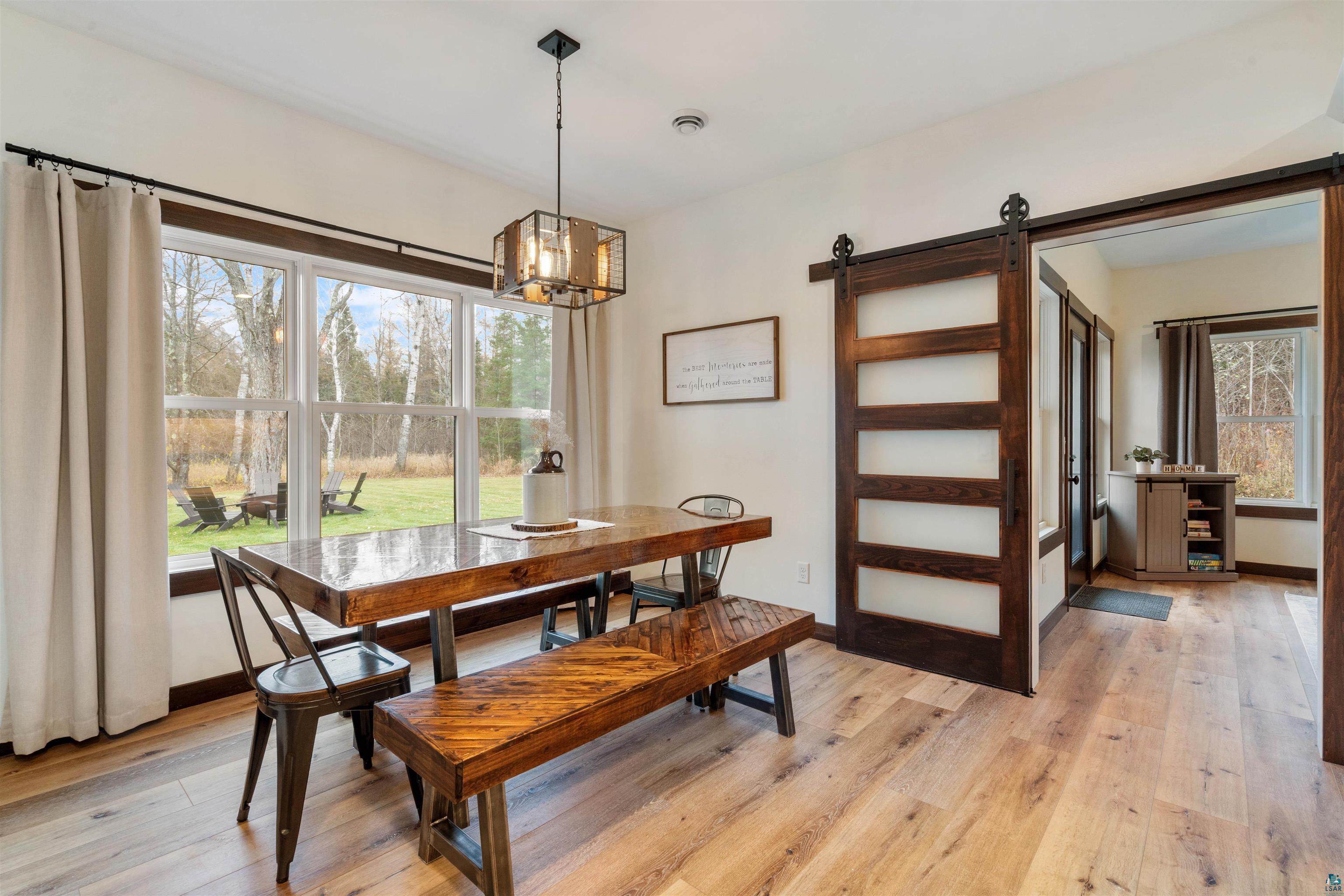 59 East Riverside Road Esko, MN 55733 - Photo 12 of 48 Dining space with a barn door and light wood-type flooring