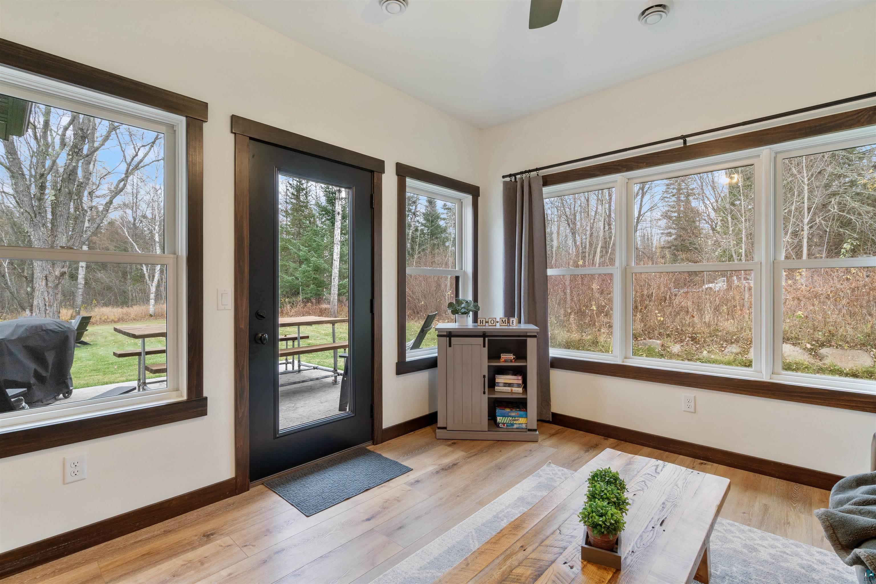 59 East Riverside Road Esko, MN 55733 - Photo 22 of 48 Doorway to outside with hardwood / wood-style flooring and a ceiling fan