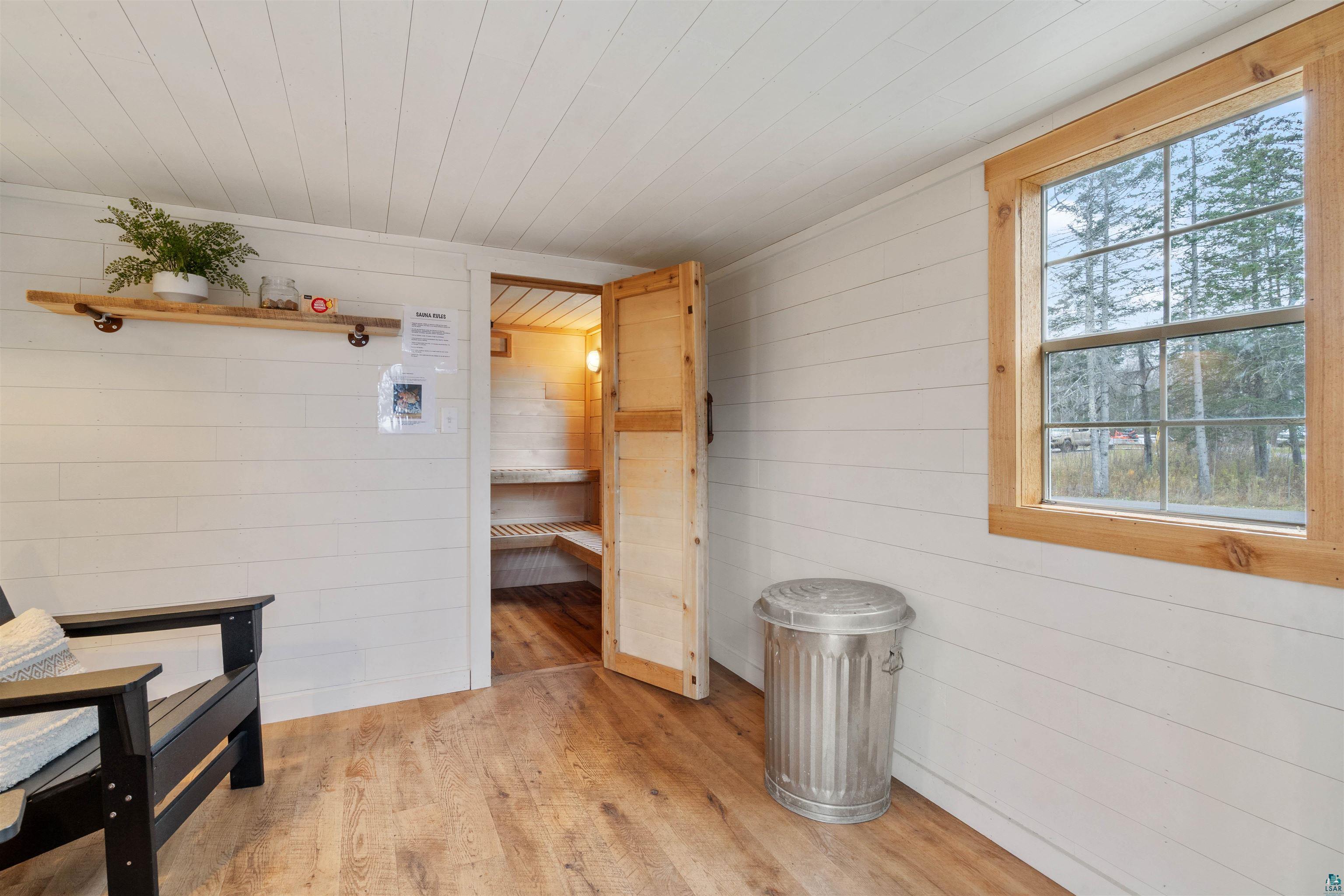 59 East Riverside Road Esko, MN 55733 - Photo 38 of 48 Interior space featuring wood ceiling, wooden walls, light wood-style floors, and a relaxing sauna