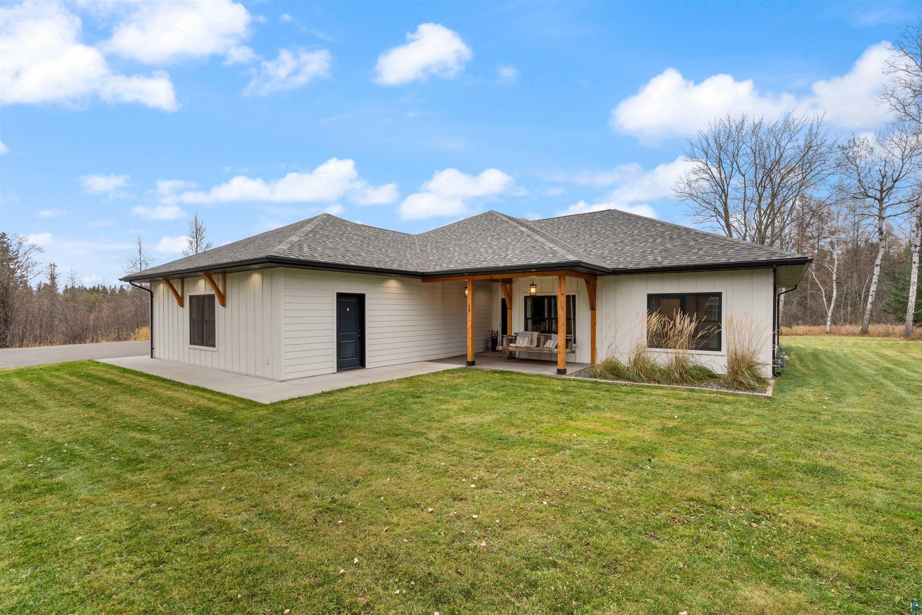 59 East Riverside Road Esko, MN 55733 - Photo 45 of 48 View of front facade with a front lawn and roof with shingles