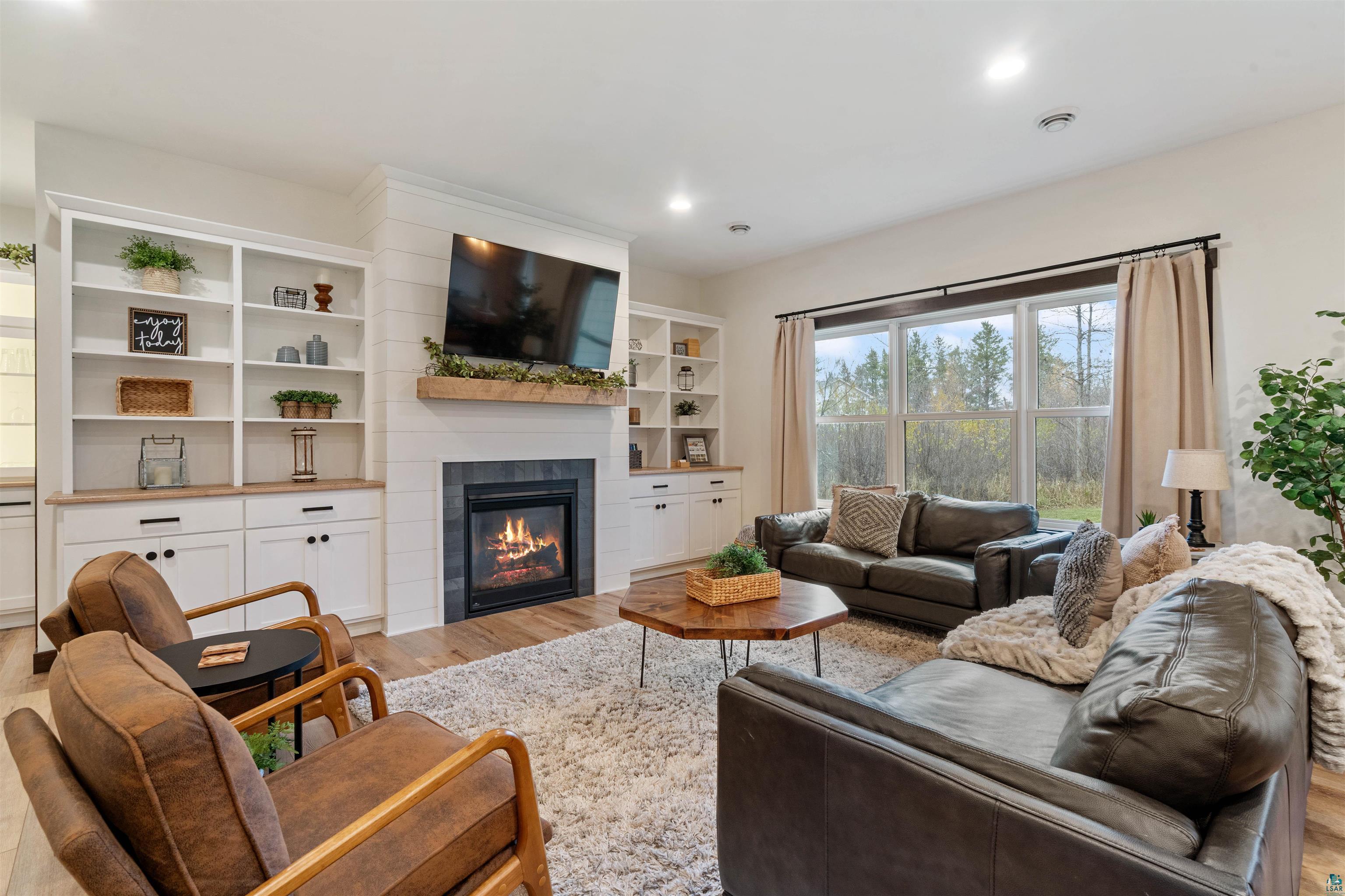 59 East Riverside Road Esko, MN 55733 - Photo 9 of 48 Living room featuring a tiled fireplace, light wood-style flooring, and recessed lighting
