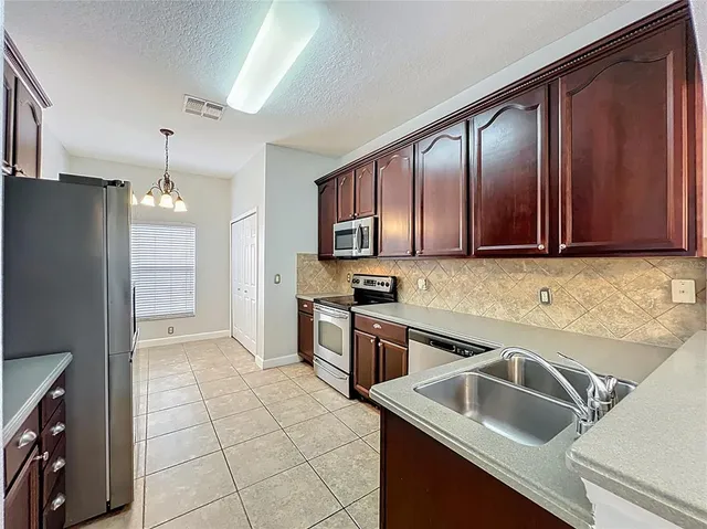 a kitchen with a sink cabinets and window