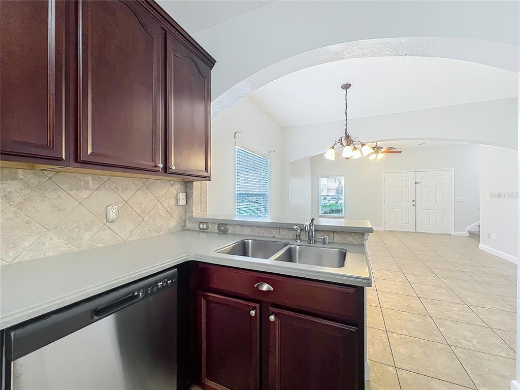16178 Old Ash Loop Orlando, FL 32828 - Photo 12 of 58 a kitchen with a sink cabinets and window
