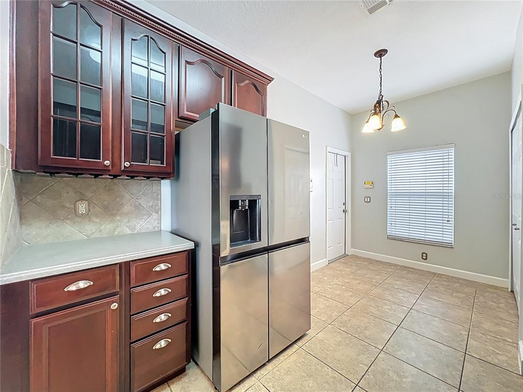 16178 Old Ash Loop Orlando, FL 32828 - Photo 13 of 58 a kitchen with stainless steel appliances granite countertop a refrigerator and a sink