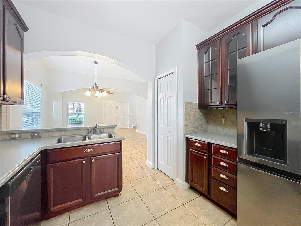16178 Old Ash Loop Orlando, FL 32828 - Photo 14 of 58 a kitchen with stainless steel appliances granite countertop a sink and cabinets