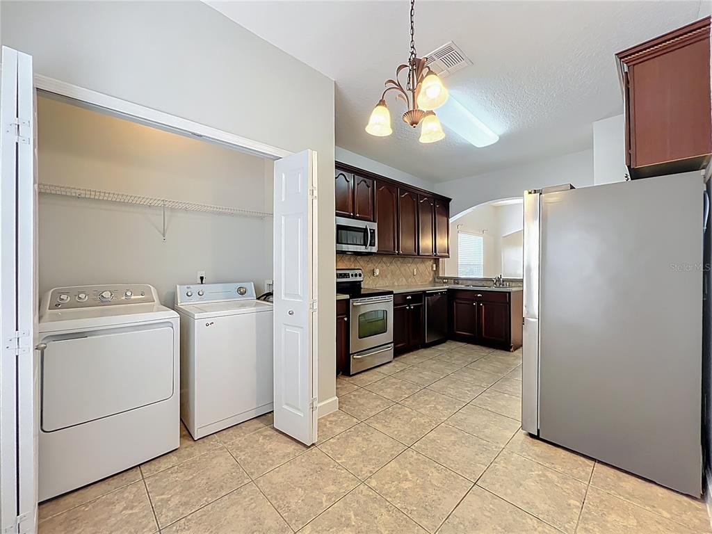 16178 Old Ash Loop Orlando, FL 32828 - Photo 17 of 58 a kitchen with cabinets and stainless steel appliances