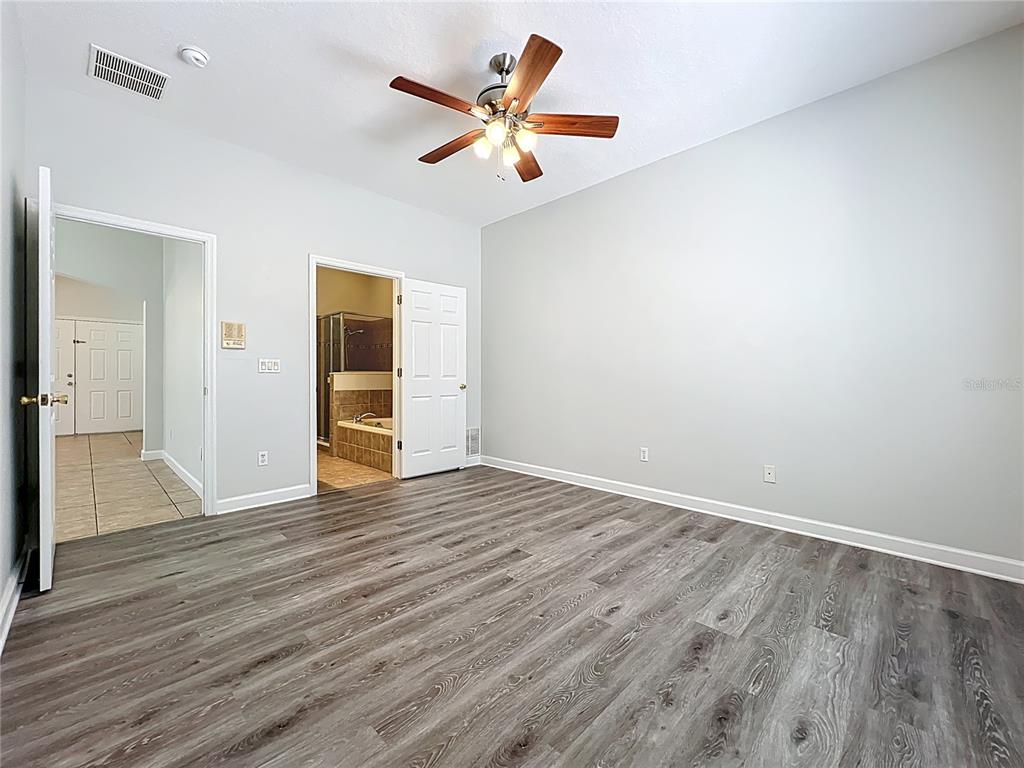 16178 Old Ash Loop Orlando, FL 32828 - Photo 19 of 58 an empty room with wooden floor and a ceiling fan