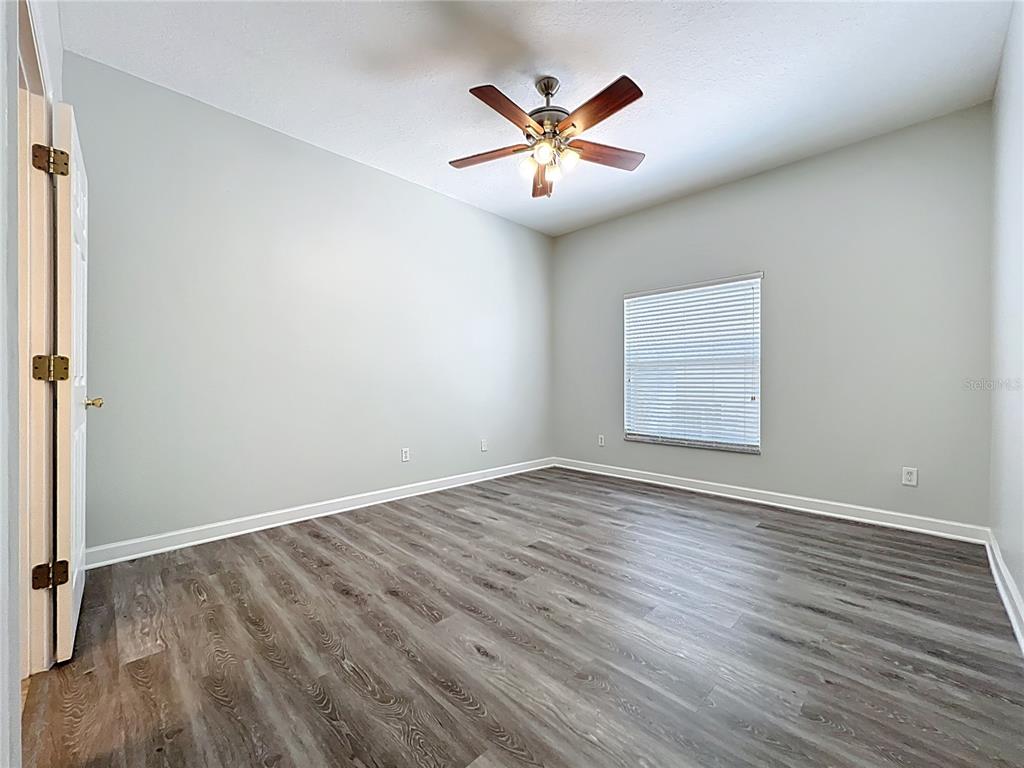 16178 Old Ash Loop Orlando, FL 32828 - Photo 20 of 58 an empty room with wooden floor and windows