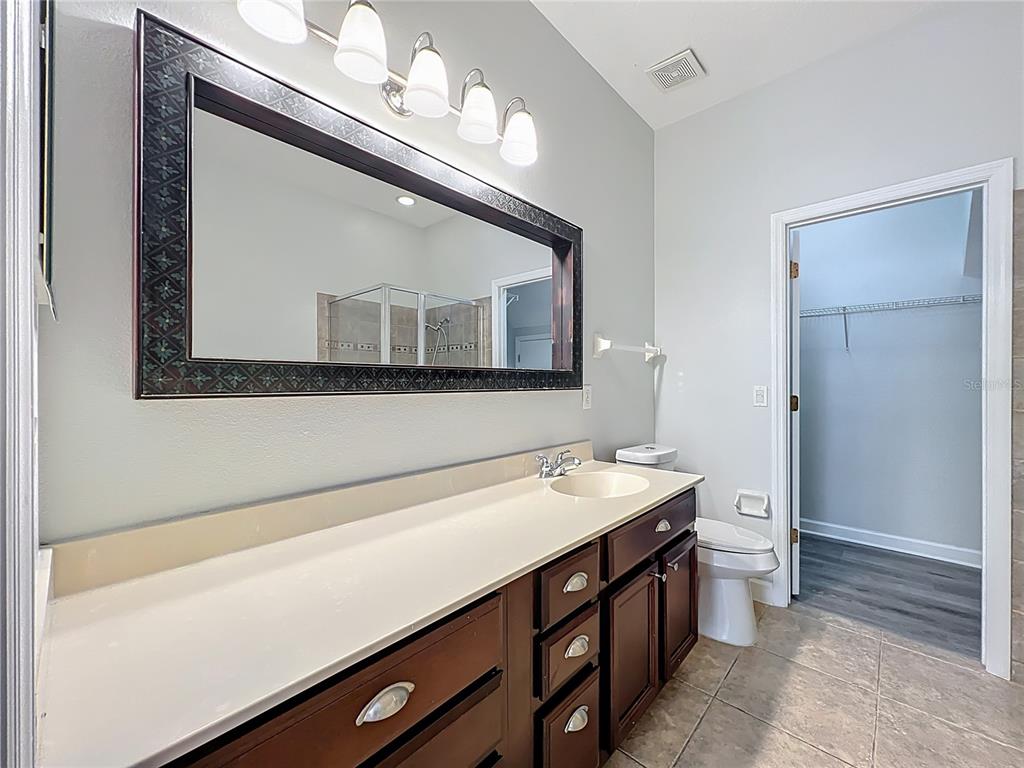 16178 Old Ash Loop Orlando, FL 32828 - Photo 22 of 58 a bathroom with a sink and a mirror