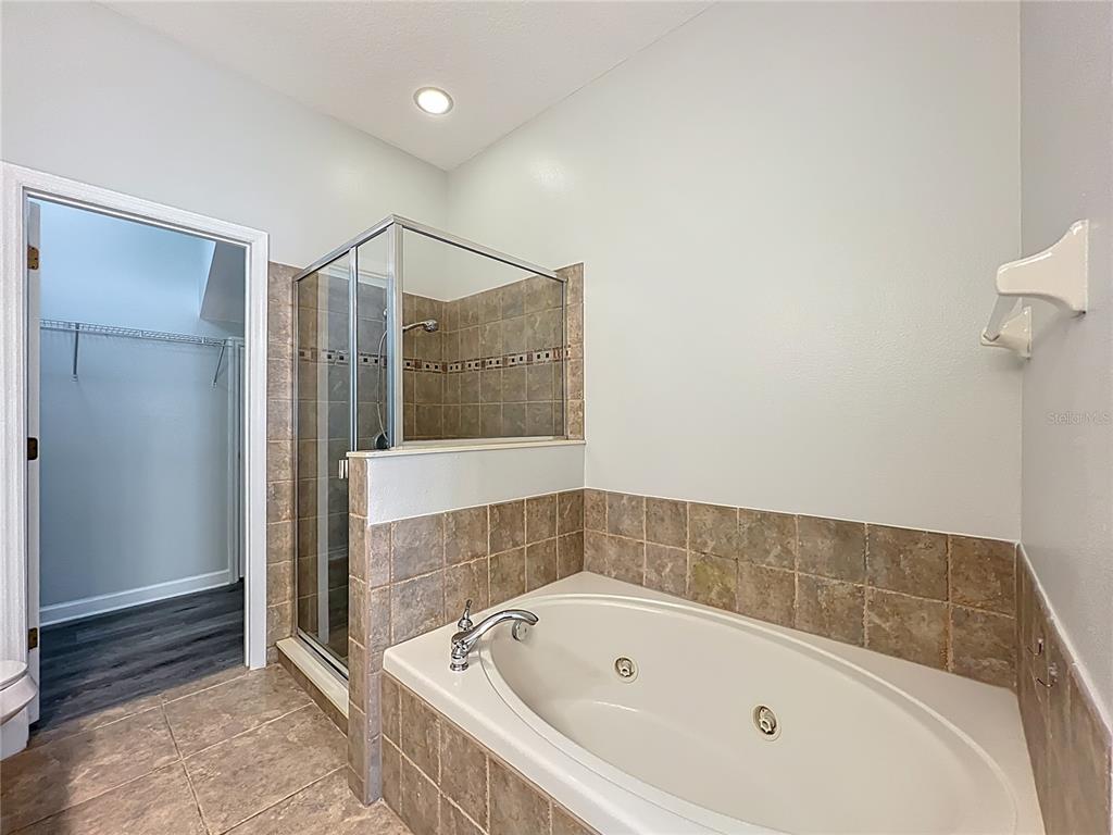 16178 Old Ash Loop Orlando, FL 32828 - Photo 24 of 58 a bathroom with a tub and shower