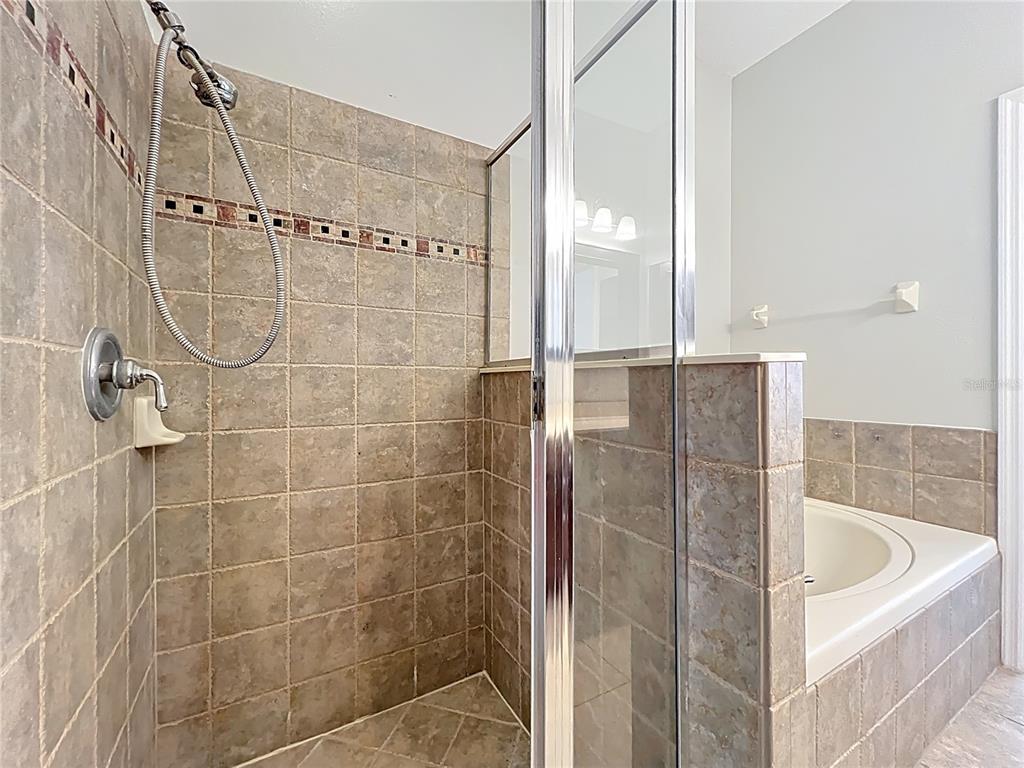 16178 Old Ash Loop Orlando, FL 32828 - Photo 25 of 58 a bathroom with a bathtub and shower