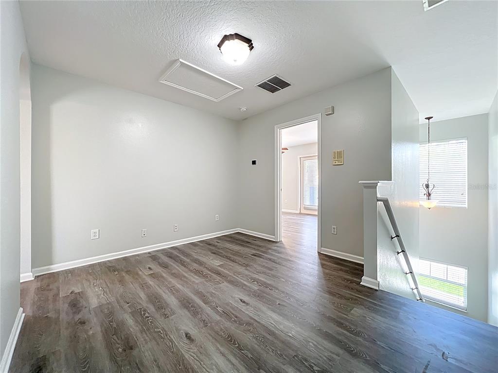 16178 Old Ash Loop Orlando, FL 32828 - Photo 30 of 58 an empty room with wooden floor and windows