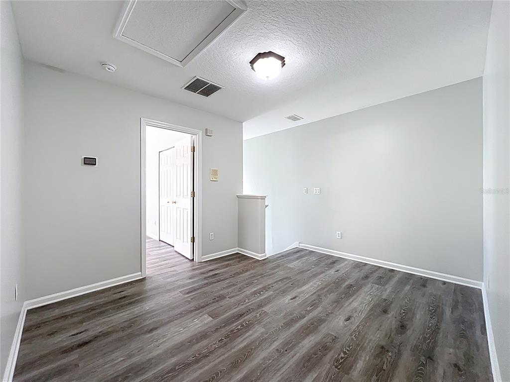 16178 Old Ash Loop Orlando, FL 32828 - Photo 31 of 58 a view of an empty room with wooden floor and a window