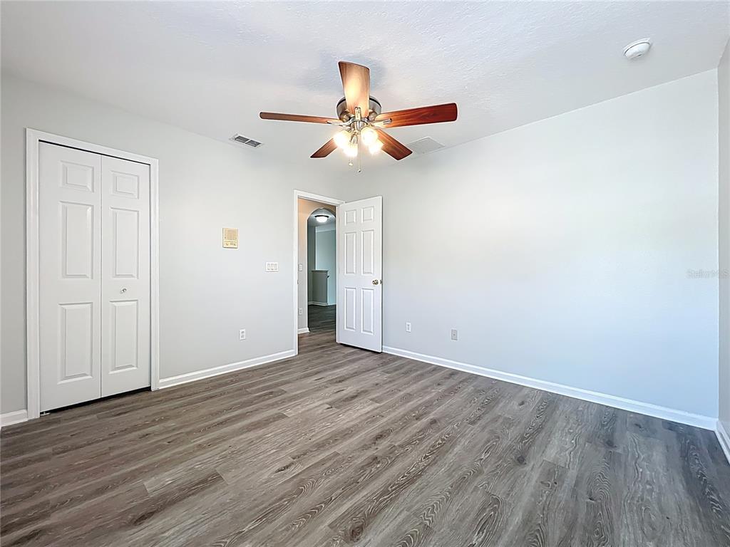 16178 Old Ash Loop Orlando, FL 32828 - Photo 33 of 58 an empty room with wooden floor ceiling fan and window