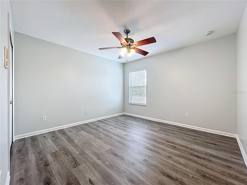 16178 Old Ash Loop Orlando, FL 32828 - Photo 34 of 58 a view of a room with wooden floor and a ceiling fan