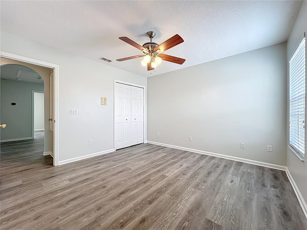 16178 Old Ash Loop Orlando, FL 32828 - Photo 35 of 58 an empty room with wooden floor fan and windows