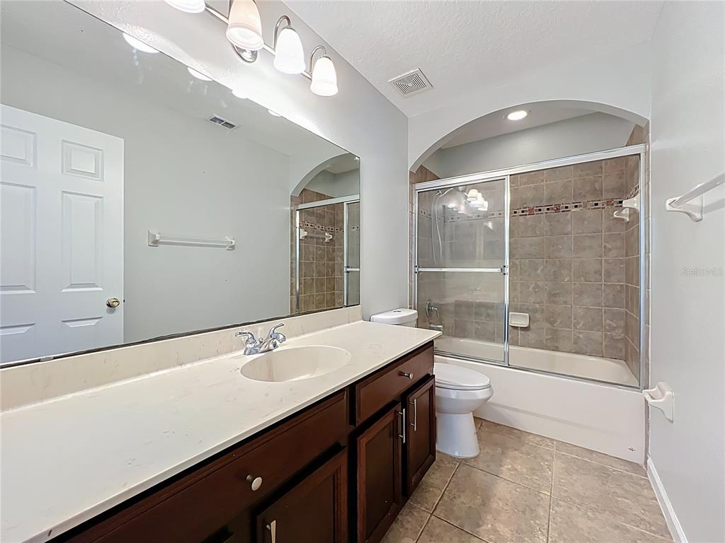 16178 Old Ash Loop Orlando, FL 32828 - Photo 36 of 58 a bathroom with a sink a toilet and shower