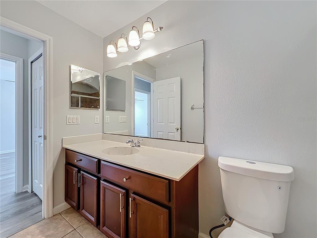 16178 Old Ash Loop Orlando, FL 32828 - Photo 37 of 58 a bathroom with a sink a toilet and mirror