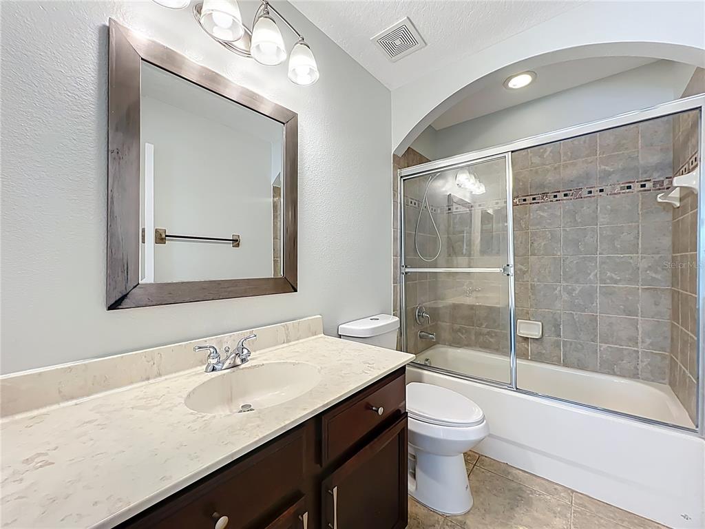 16178 Old Ash Loop Orlando, FL 32828 - Photo 41 of 58 a bathroom with a sink a toilet and shower