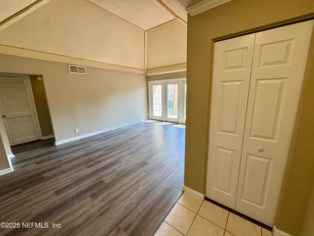a view of a hallway with wooden floor and a fireplace