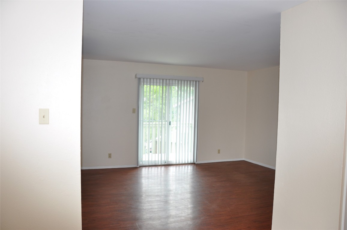 10810 Topperwein Drive, Unit C Austin, TX 78758 - Photo 6 of 11 Spare room with wood finished floors and baseboards