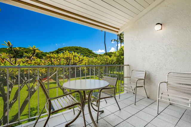 a view of a chairs and table in the balcony