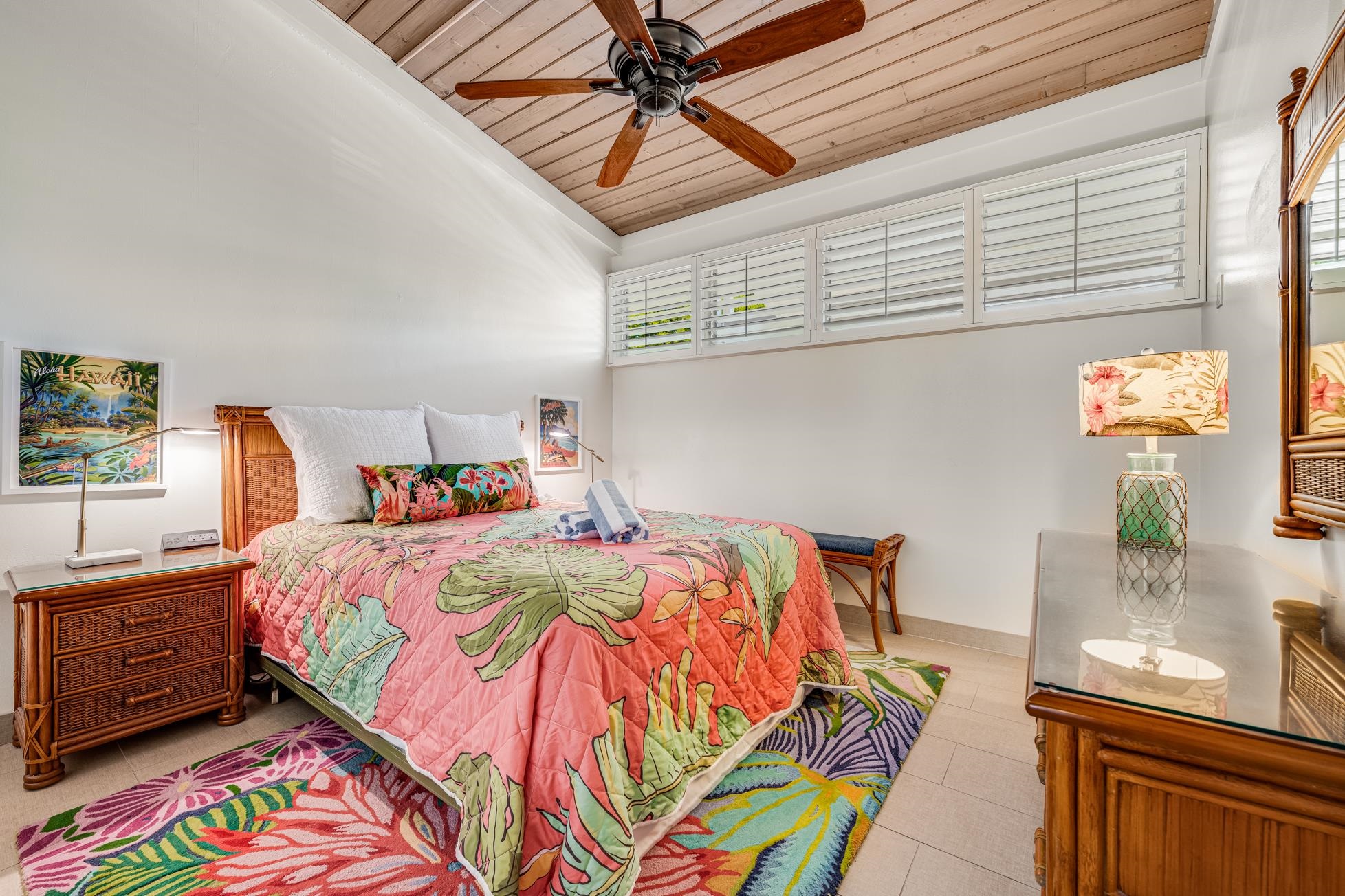 5315 Lower Honoapiilani Road, Unit F249 Lahaina, HI 96761 - Photo 13 of 33 a bedroom with a bed and painting on the wall