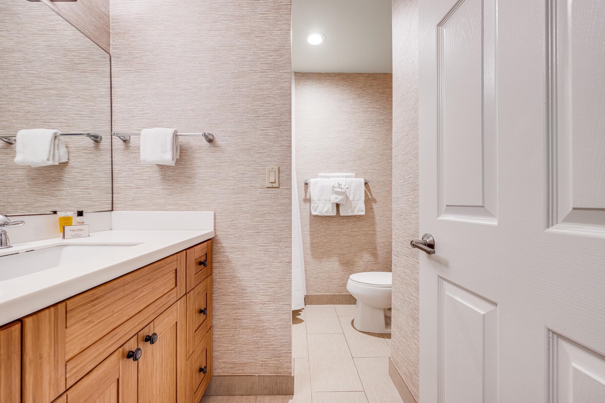 5315 Lower Honoapiilani Road, Unit F249 Lahaina, HI 96761 - Photo 17 of 33 a bathroom with a sink a toilet and a mirror