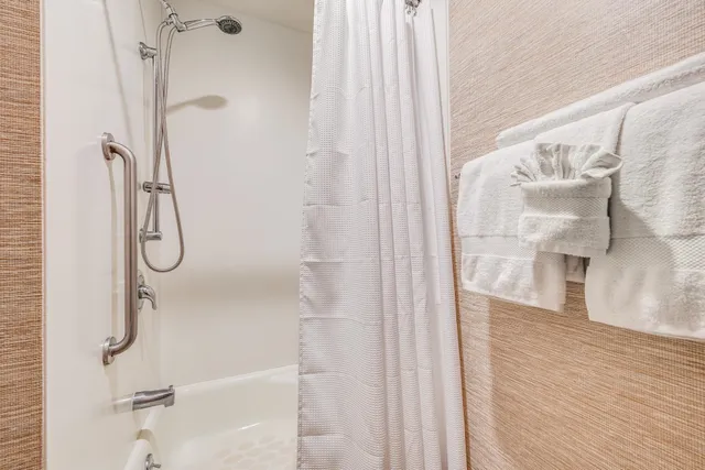 a bathroom with a glass shower door