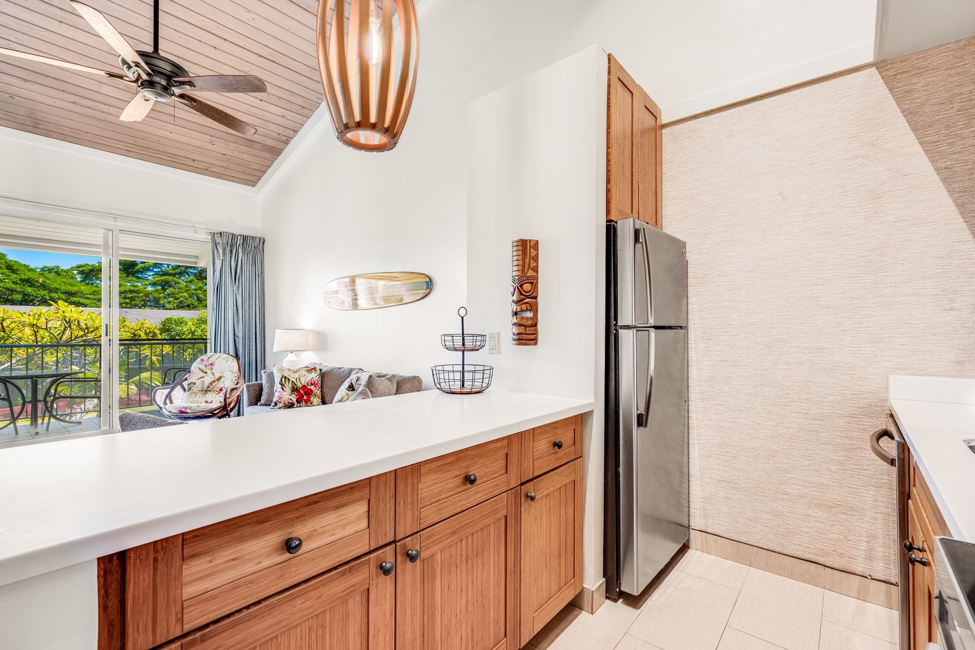 5315 Lower Honoapiilani Road, Unit F249 Lahaina, HI 96761 - Photo 5 of 33 a kitchen with stainless steel appliances a sink and a refrigerator