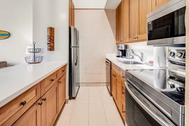 a kitchen with stainless steel appliances granite countertop a sink and a stove