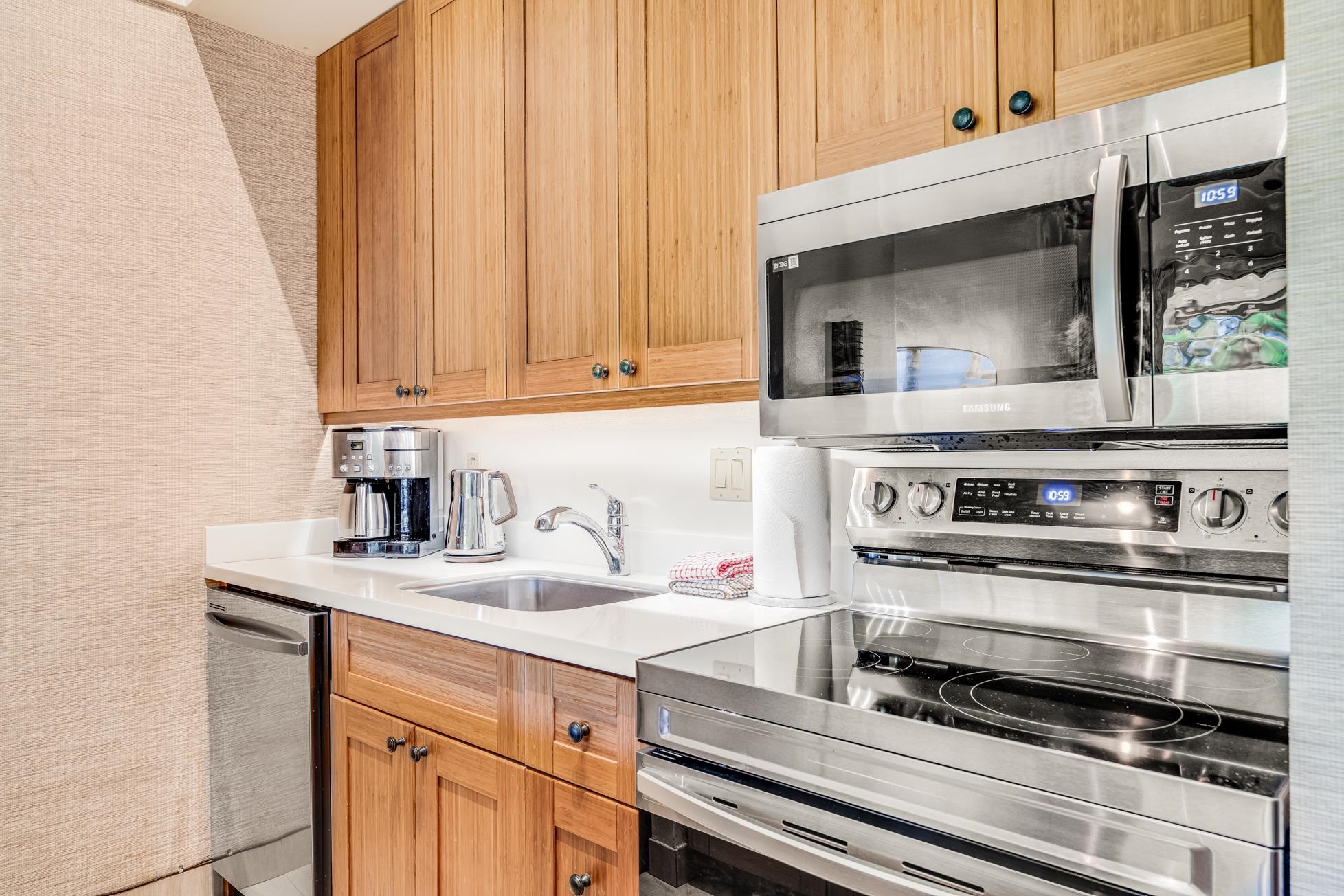 5315 Lower Honoapiilani Road, Unit F249 Lahaina, HI 96761 - Photo 7 of 33 a kitchen with a stove and a white cabinets