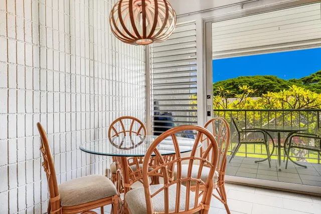 a view of a chairs and table in the balcony