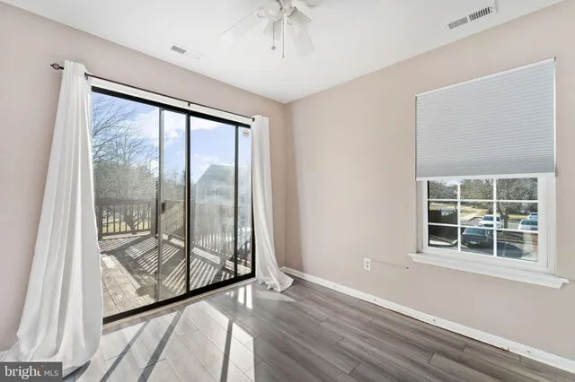 a view of a hallway view with wooden floor and staircase